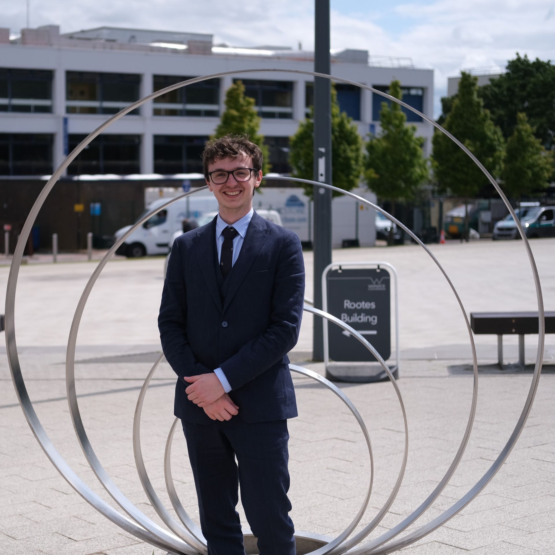 Thomas Chaplin standing in front of the Hawaiian earring sculpture at the Unviersity of Warwick